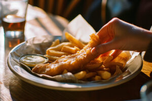 Fish and chips sitting on a bar counter